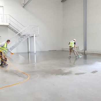 builders cleaning screed floor