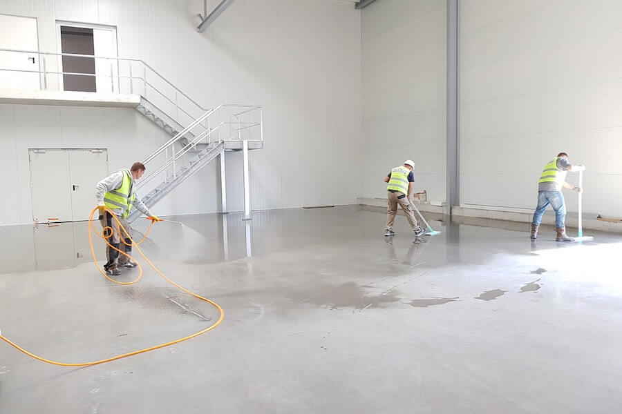 builders cleaning screed floor