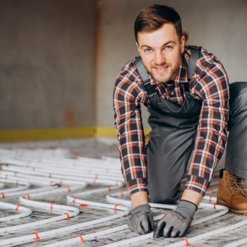 man installing underfloor heating