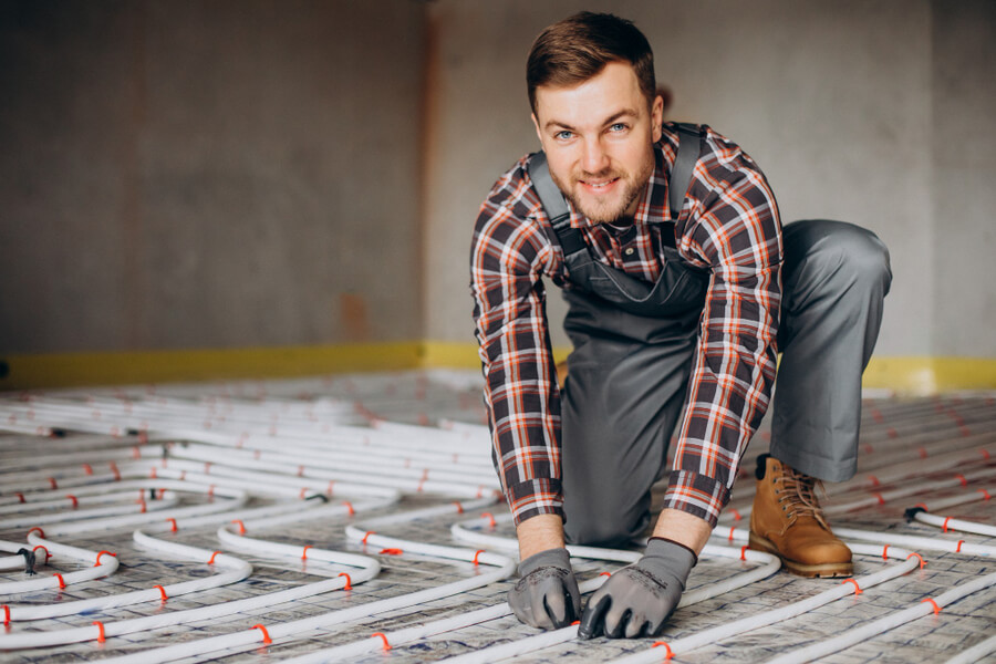 man installing underfloor heating