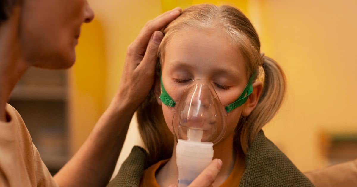 Asthma girl with inhalation with nebulizer