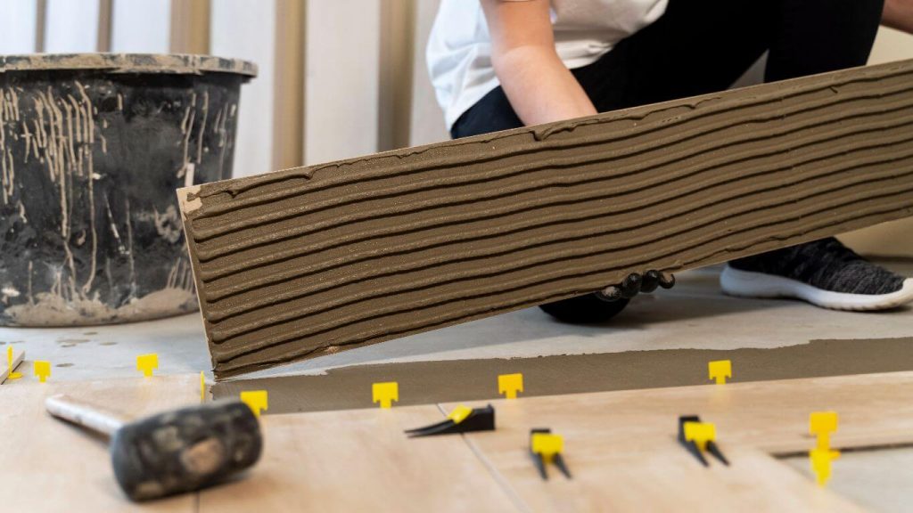 worker laying insulation for underfloor heating